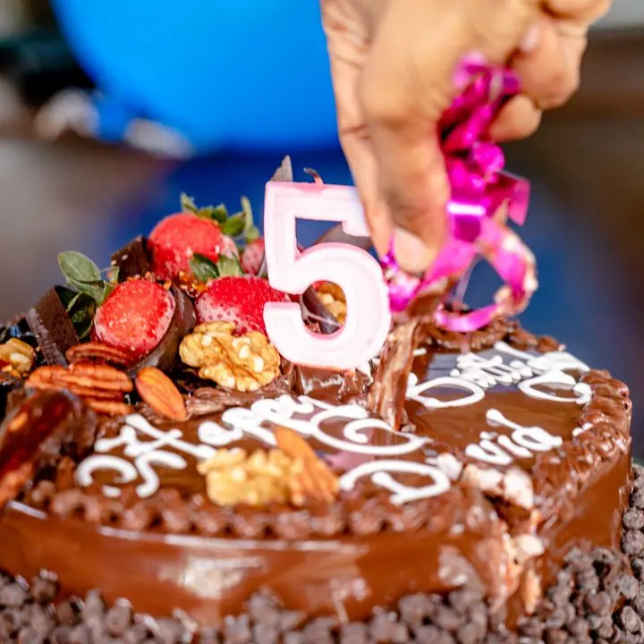 Chocolate Celebration Cake — Chocolate cake with number topper and decorations.