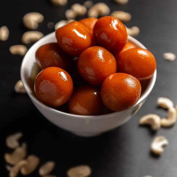 Gulab Jamun — Khoya dumplings in rose-cardamom syrup.