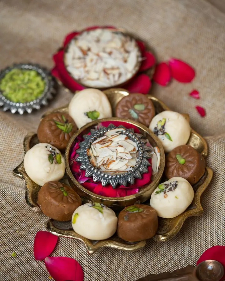 Platter of assorted sandesh, pantua and barfi with rose petals