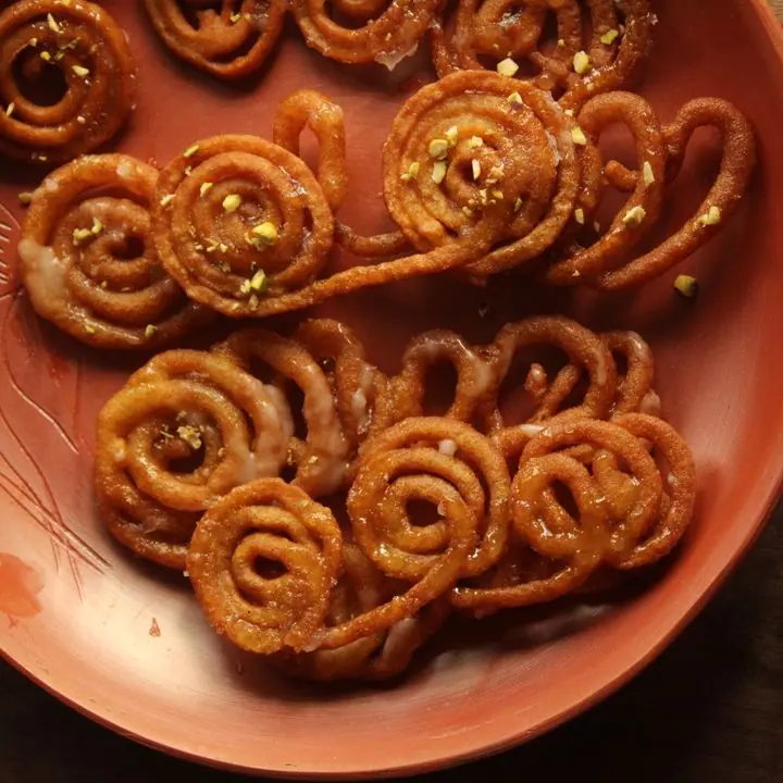 Jalebi — Crisp saffron spirals, fried and dunked in syrup.