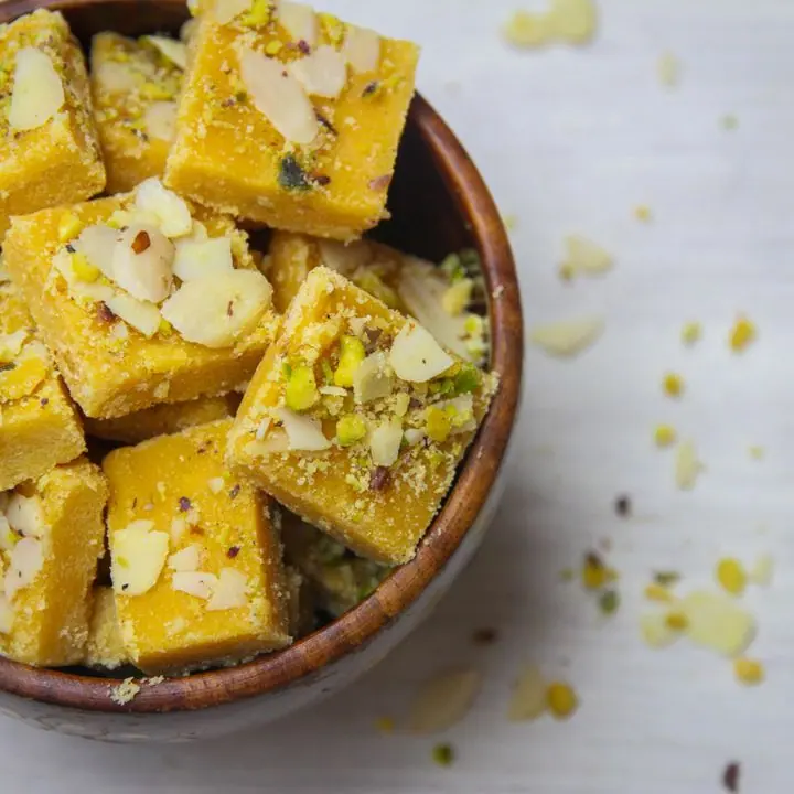 Besan Barfi — Ghee-roasted besan squares with almonds.